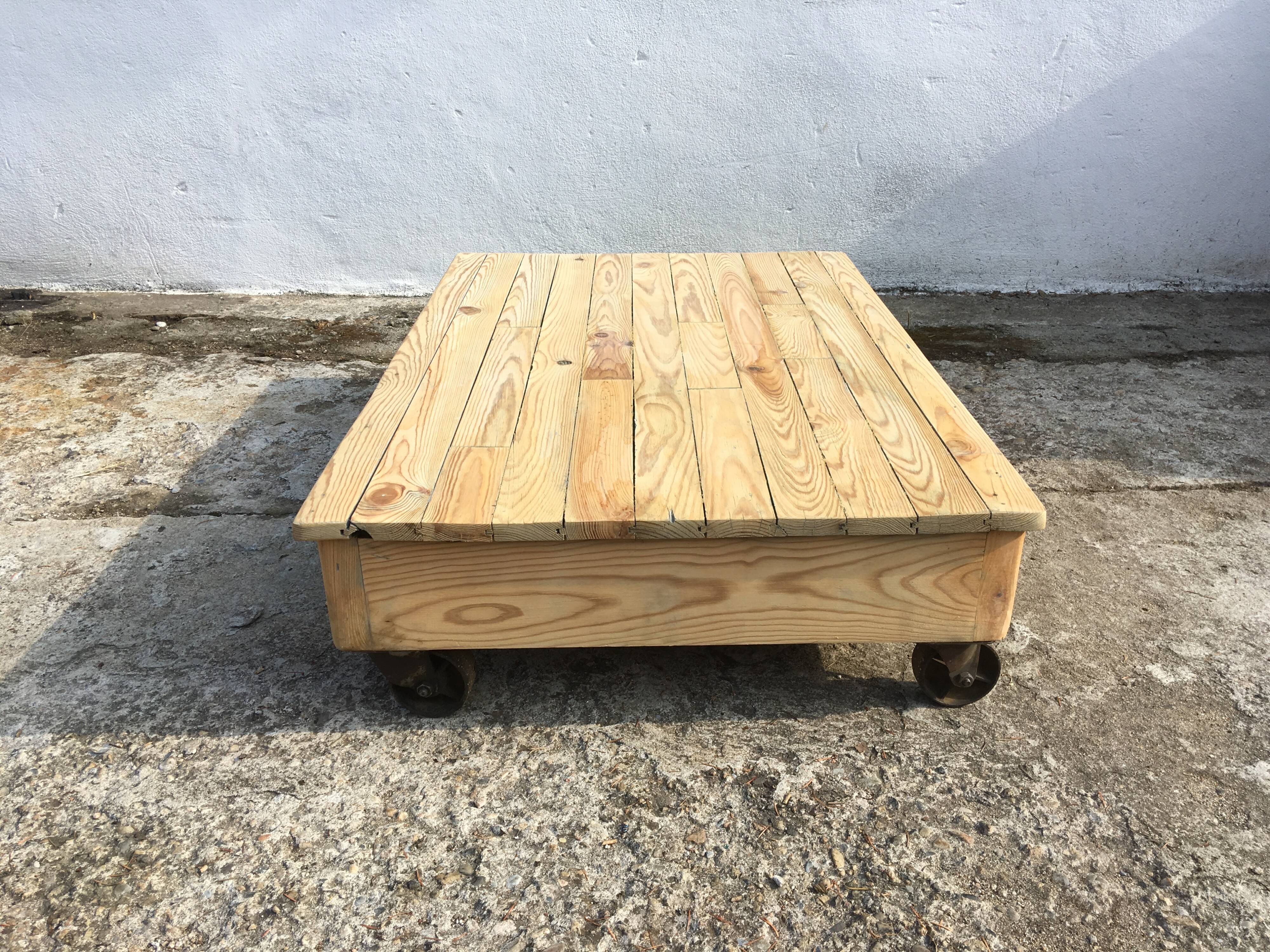 Old wooden school platform bass table on metal wheels