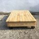 Old wooden school platform bass table on metal wheels