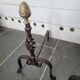 Old pair of wrought iron pegs with brass pine cone