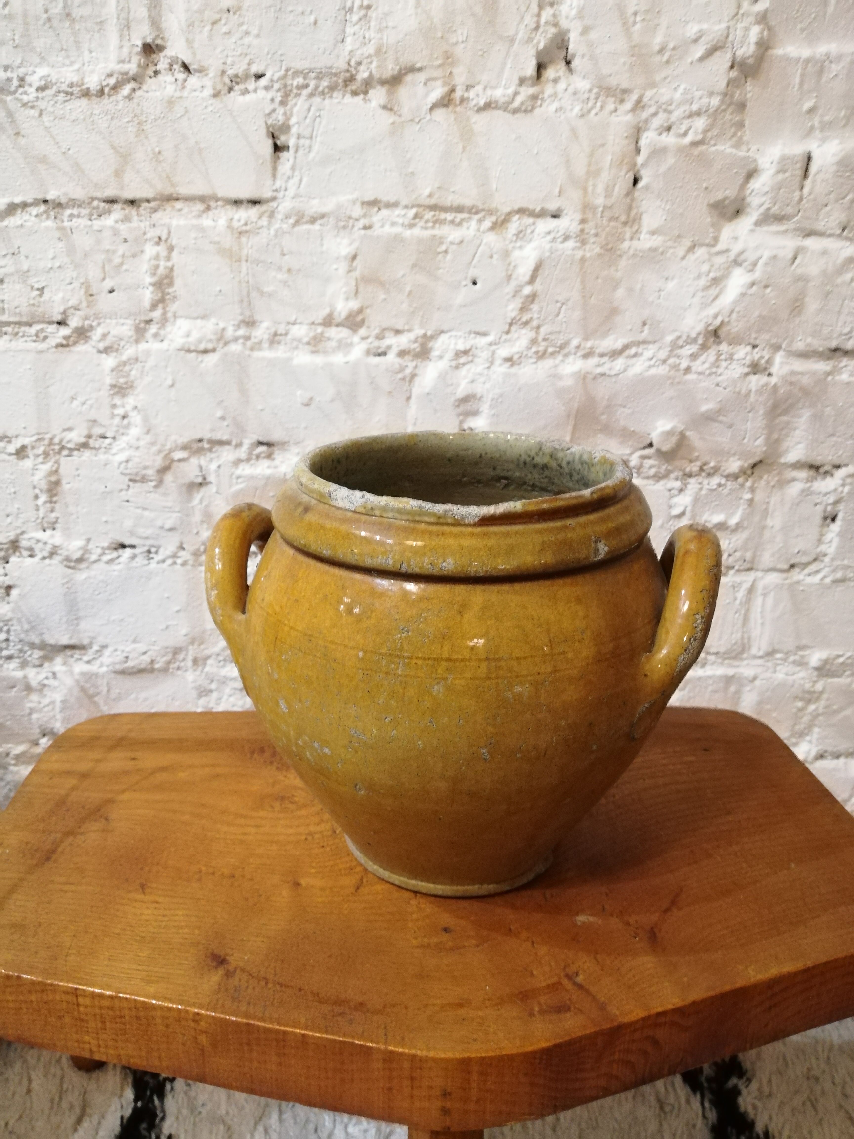 Old yellow glazed terracotta pot