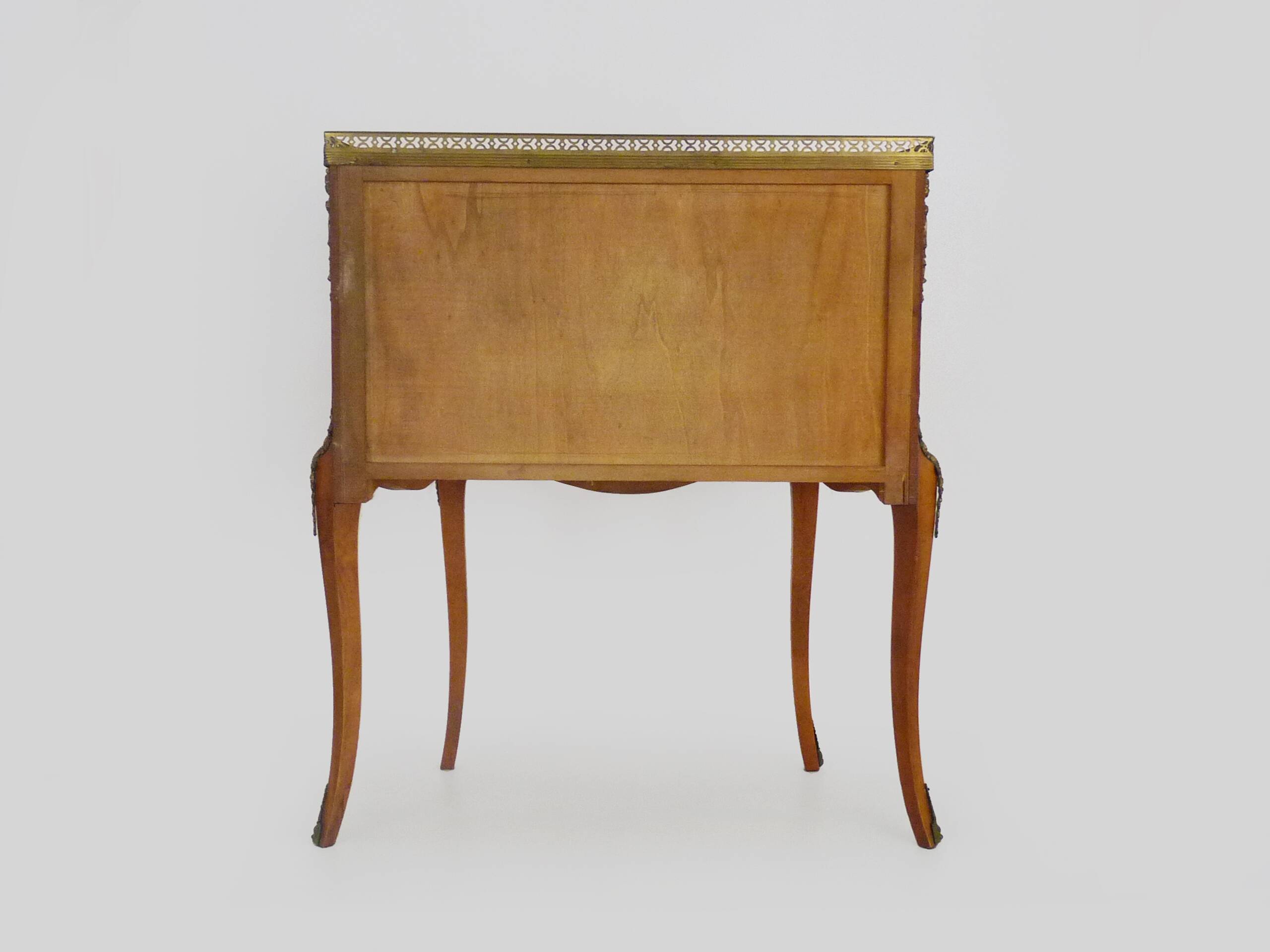 Baroque style wooden chest of drawers with bronze frieze.