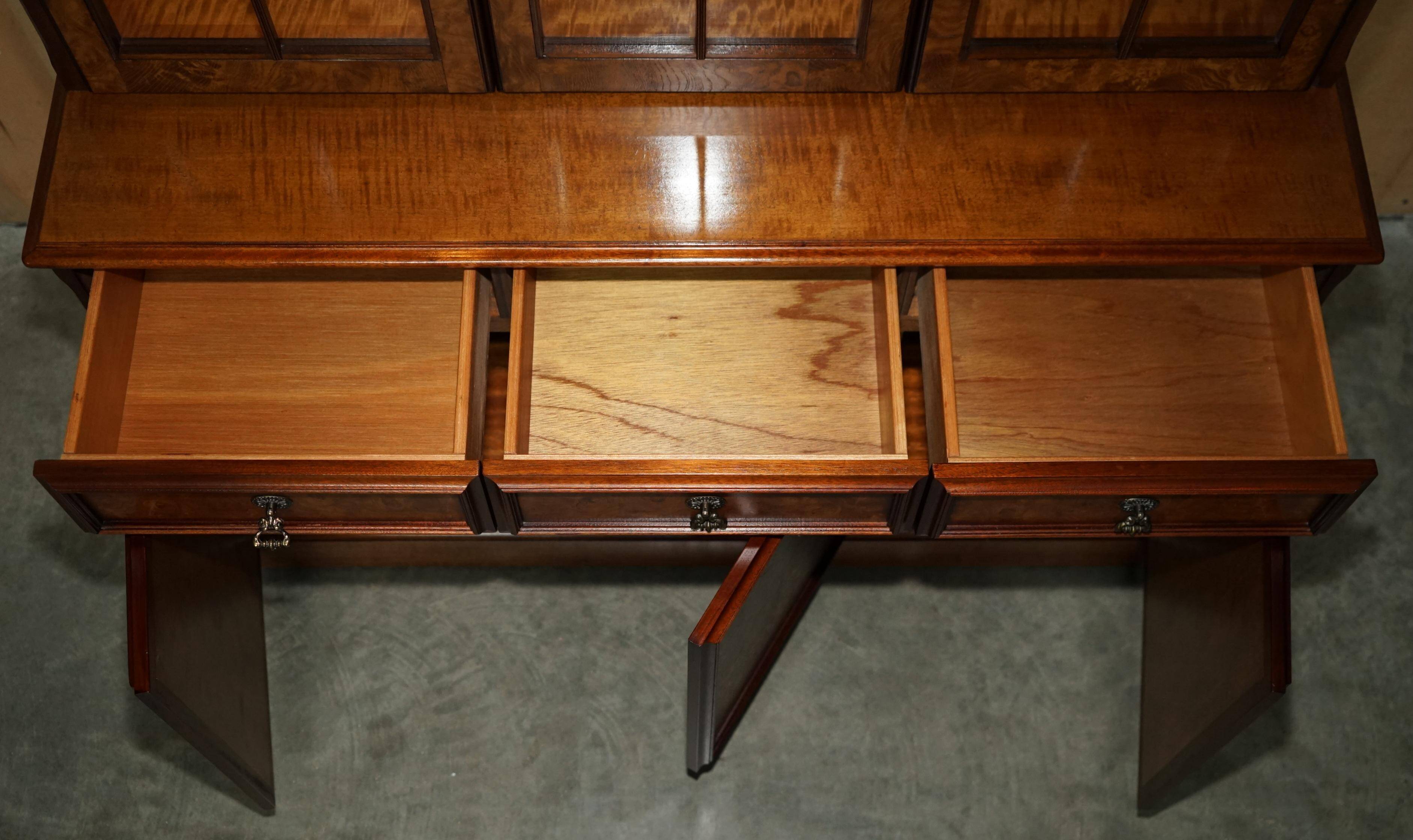 Vintage walnut burr buffet with glass and lighting, Art Deco style.