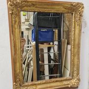 Antique gilded mirror, 19th century Empire style.