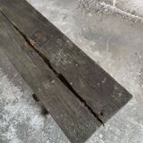 Dark brown wood and black cast-iron antique garden bench with weathered solid-wood seat