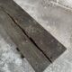 Dark brown wood and black cast-iron antique garden bench with weathered solid-wood seat