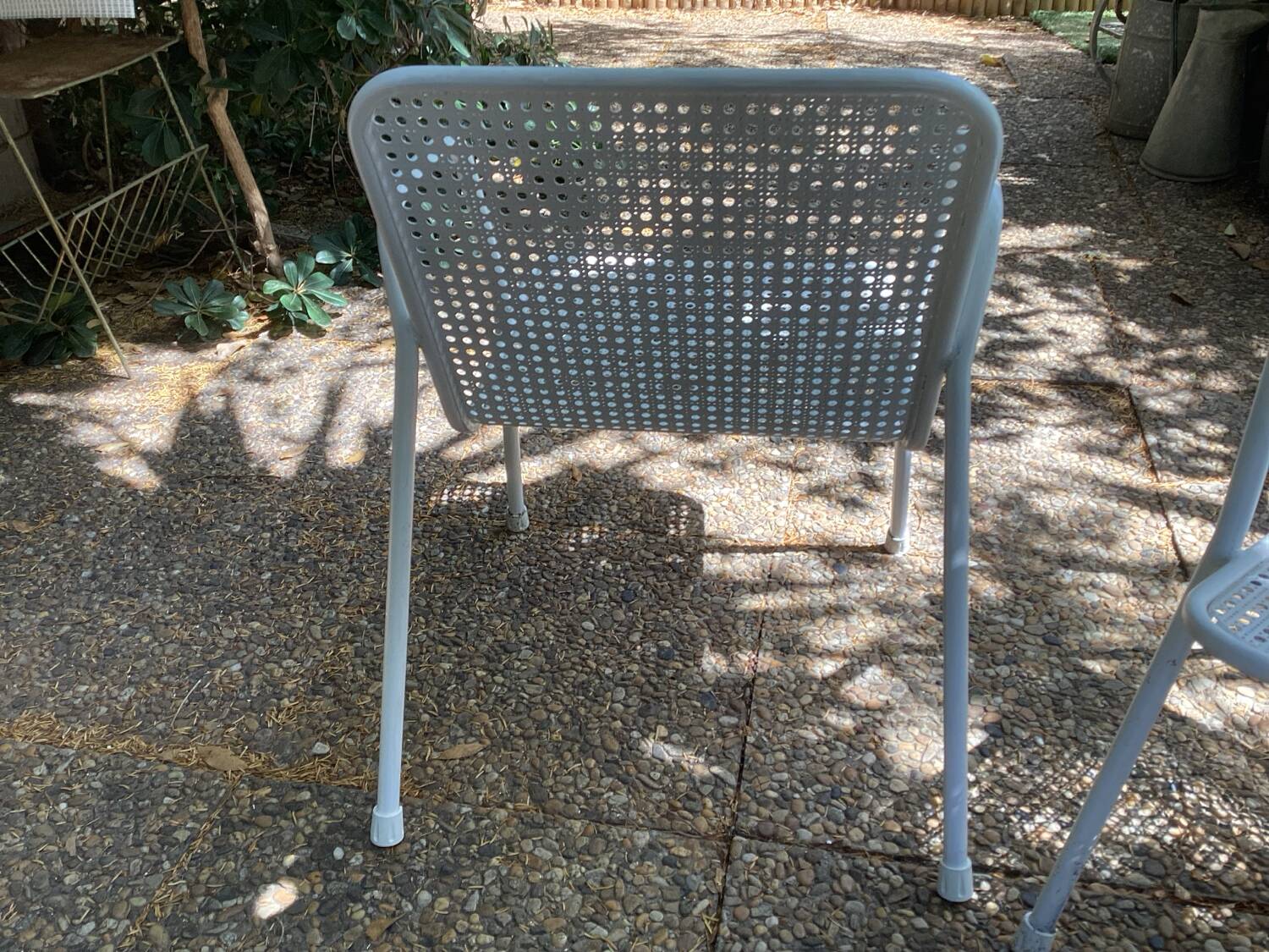 Perforated metal armchairs