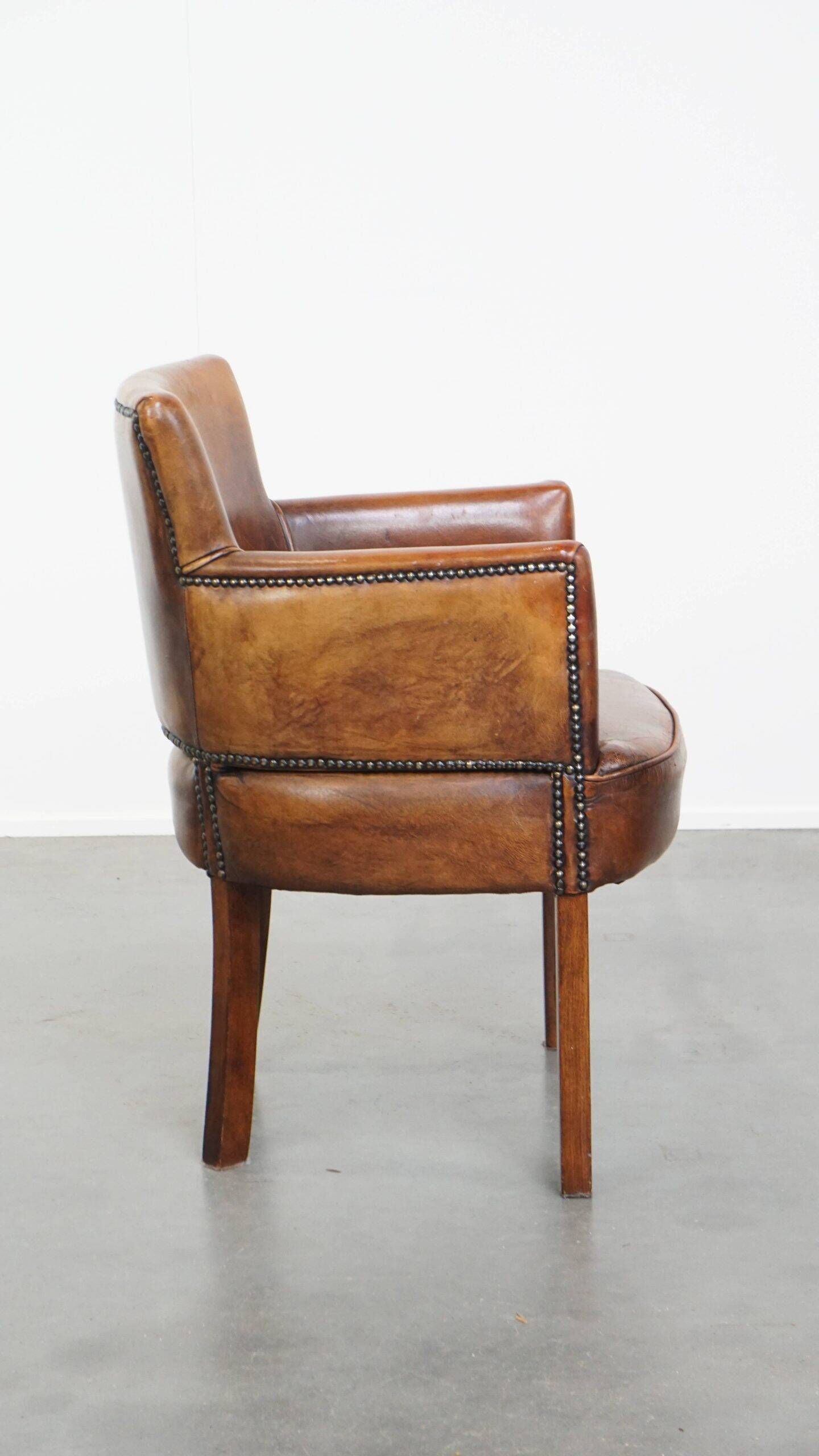 Amazing cognac-coloured sheepskin dining/side chair with armrests
