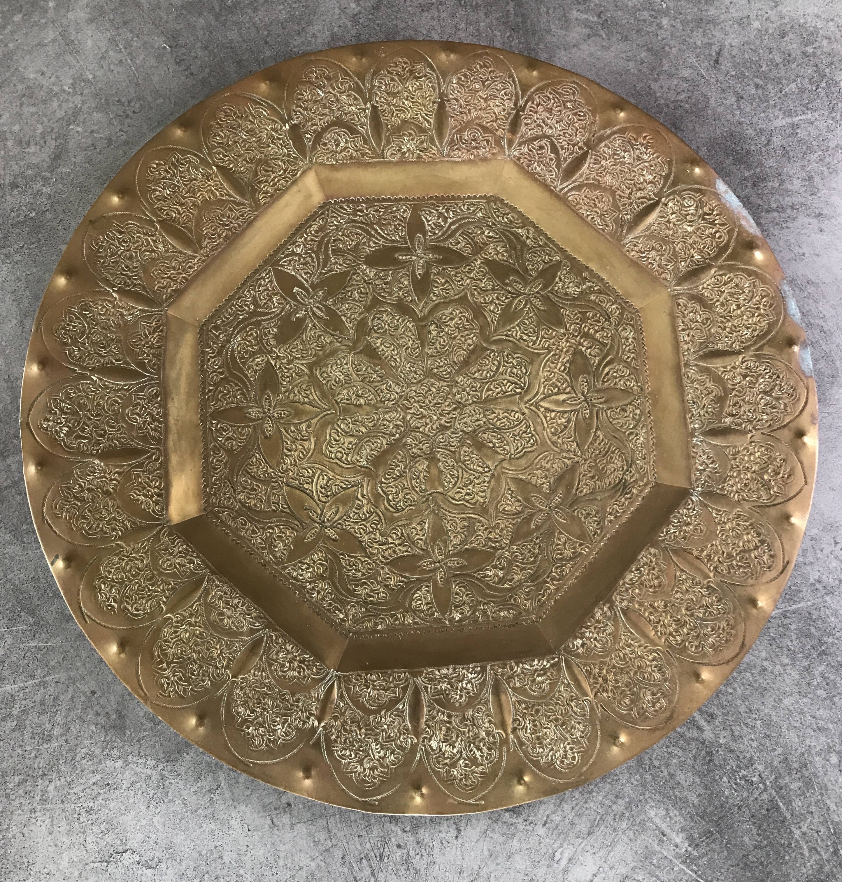 Oriental brass tray with chiseled decoration of arabesques and flowers