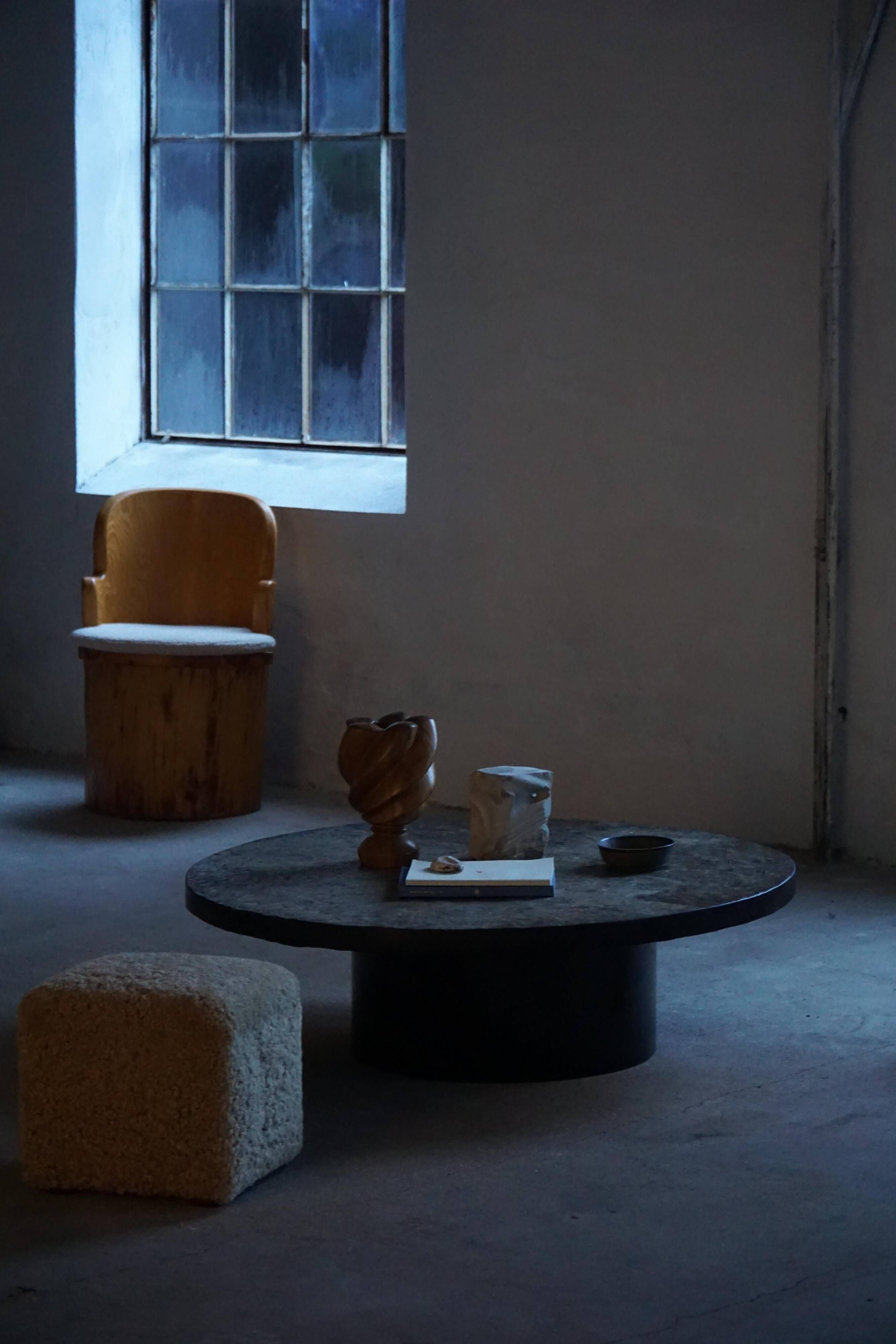 Round brutalist coffee table in stone and steel, mid-century French modernism, 1970s.