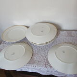 Set of 11 flat white earthenware plates with gold edging