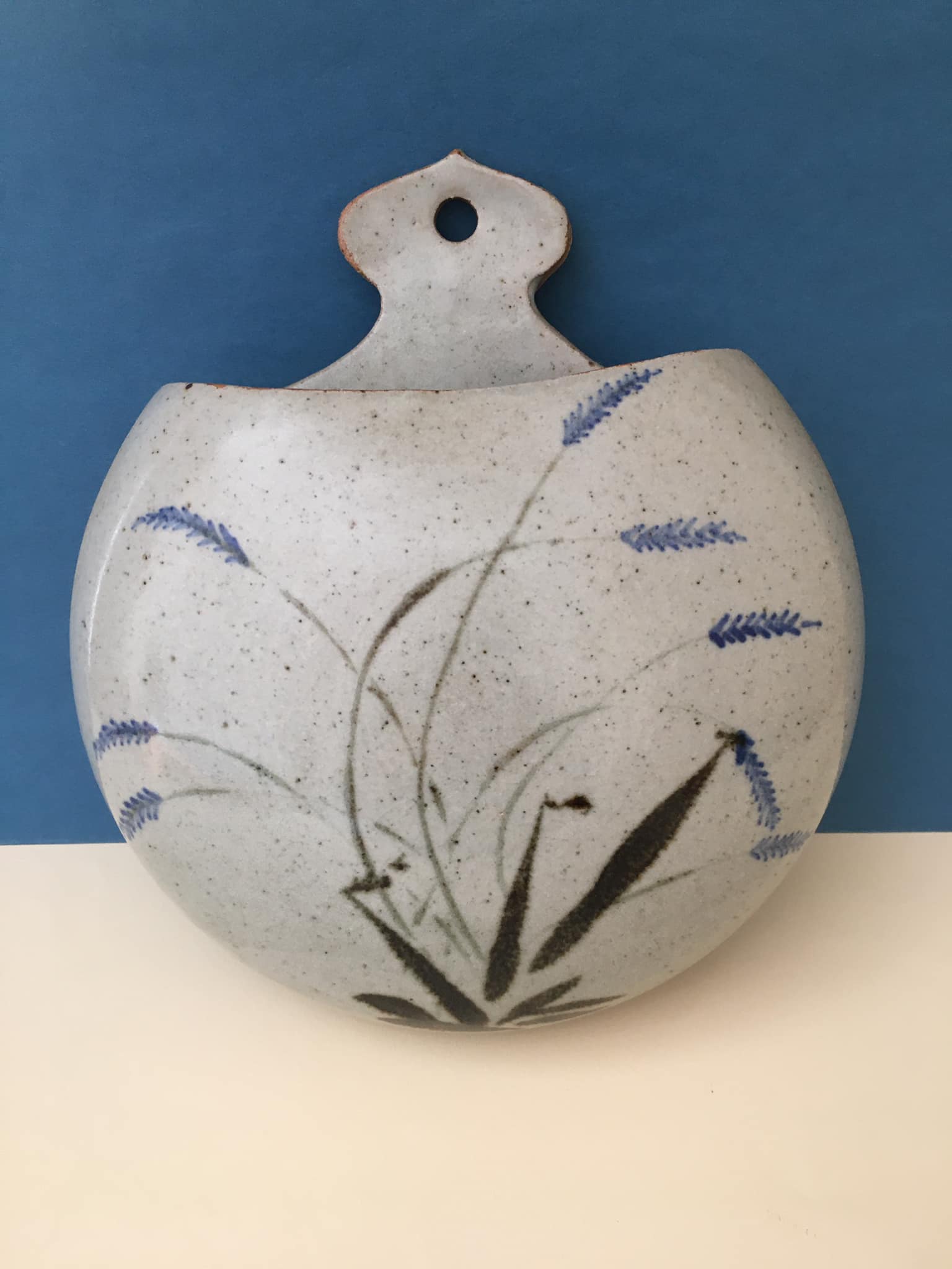 Ceramic wall plant holder with floral motifs, unknown signature