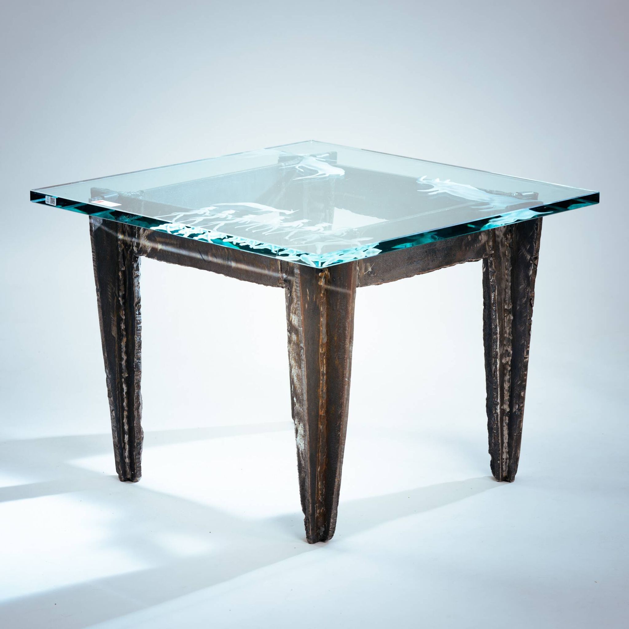 2 brutalist steel side tables with primitive  scene motifs etched glass