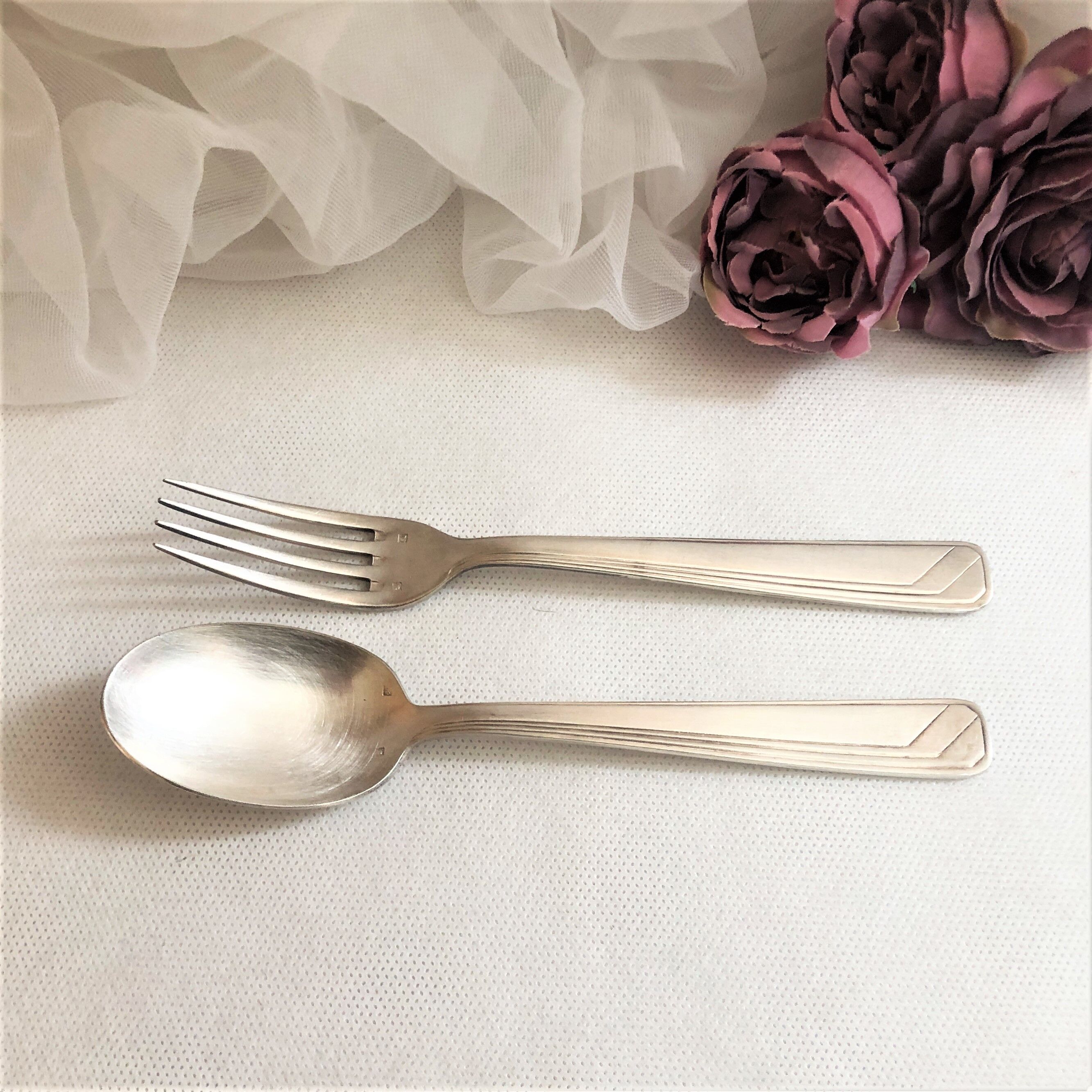Set of 2 silver metal cutlery with punches