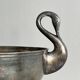 Large champagne bucket with patinated metal swan handles.
