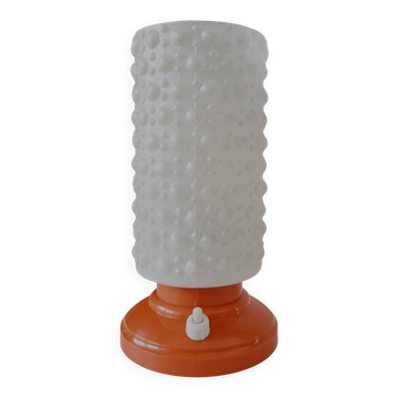 Vintage tafellamp met oranje kunststof voet en glazen kapje uit de jaren 60