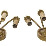 Pair of wall sconces with a relief decoration of a Bacchus mask.