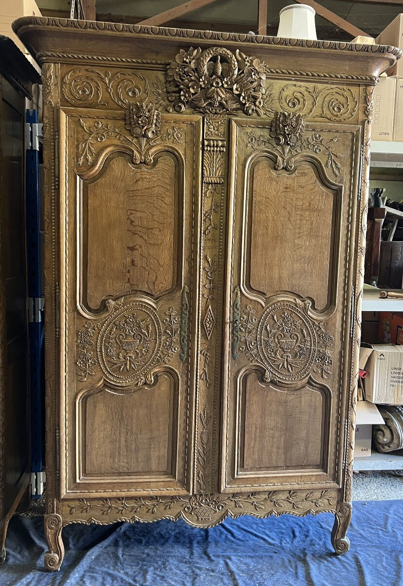 19th-century Norman wedding armoire, with bouquets of flowers and doves.