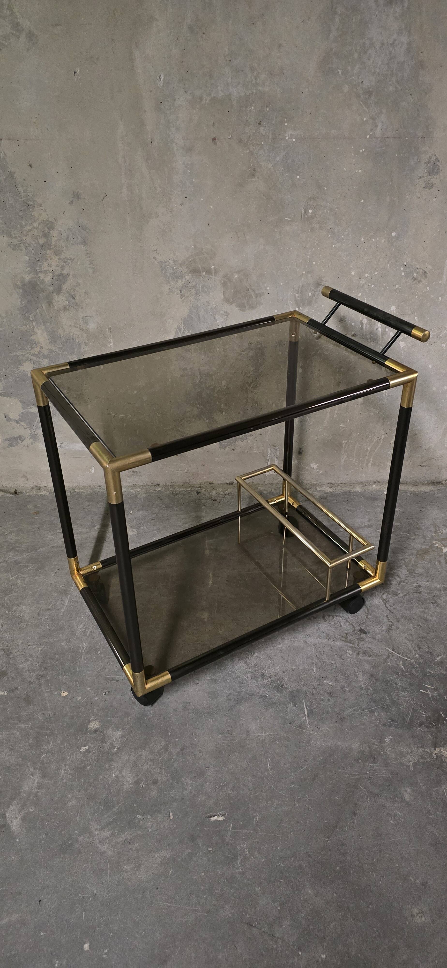 Black metal and brass rolling dessert trolley, smoked glass, 1970s.