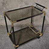 Black metal and brass rolling dessert trolley, smoked glass, 1970s.