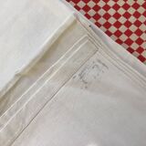 Sheet marked AT in red cross stitch