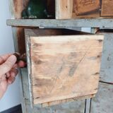 Craft cabinet with drawers with a very old tobacco advertisement in the background