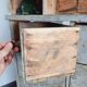 Craft cabinet with drawers with a very old tobacco advertisement in the background