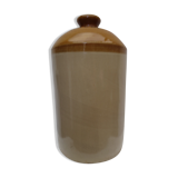 Old wiskhey jug in sand