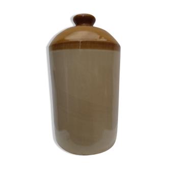 Old wiskhey jug in sand