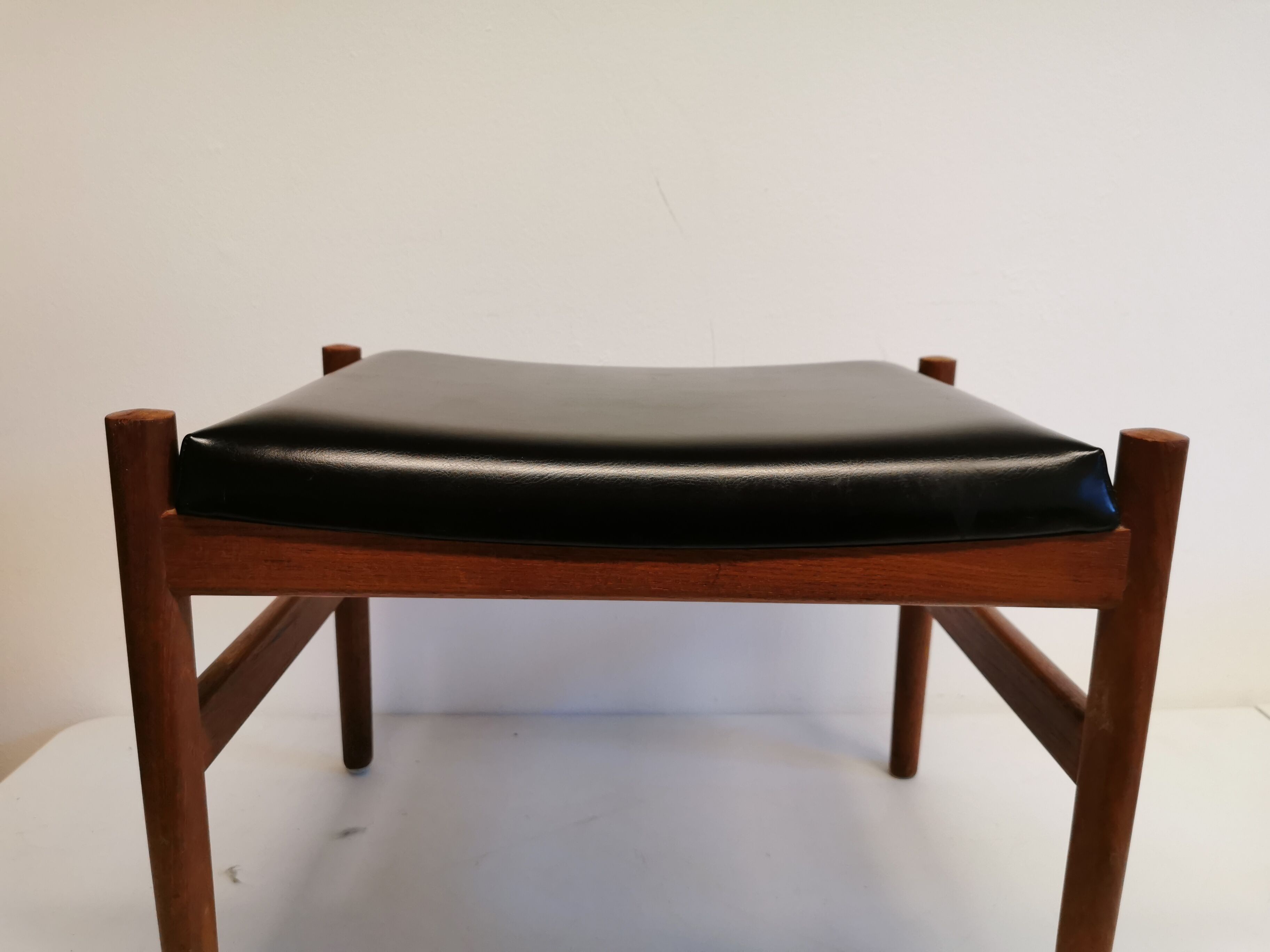 Danish designed footstool, in teak and black skai. Made at Spøttrup furniture factory in the 1960s.
