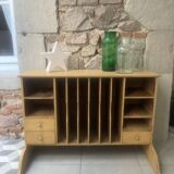 On a piece of furniture with sorting lockers and drawers