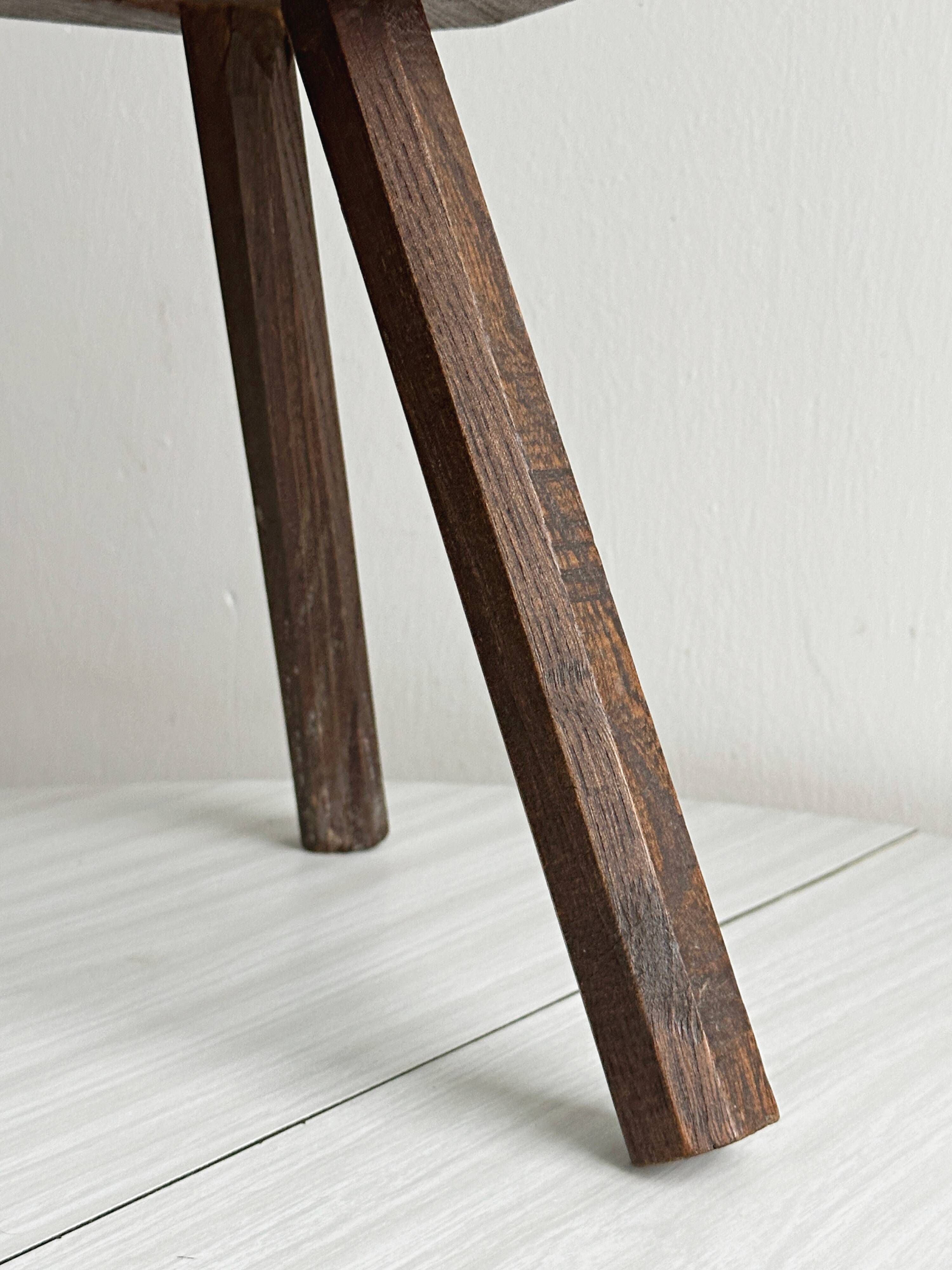 Small dark wooden tripod stool