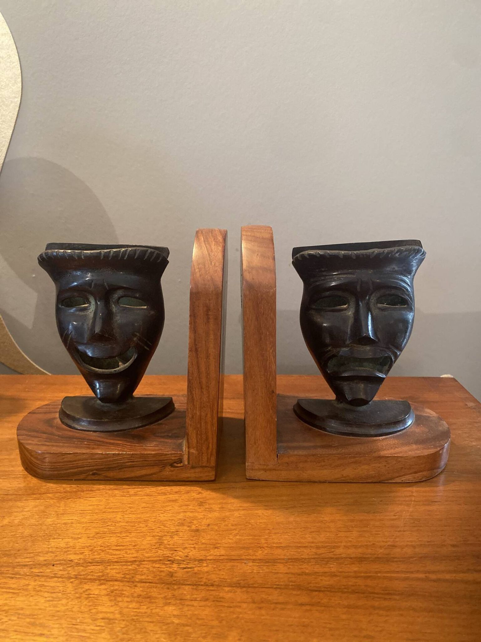 Pair of bronze bookends with masks