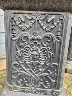 Large antique cast iron vases on pedestal