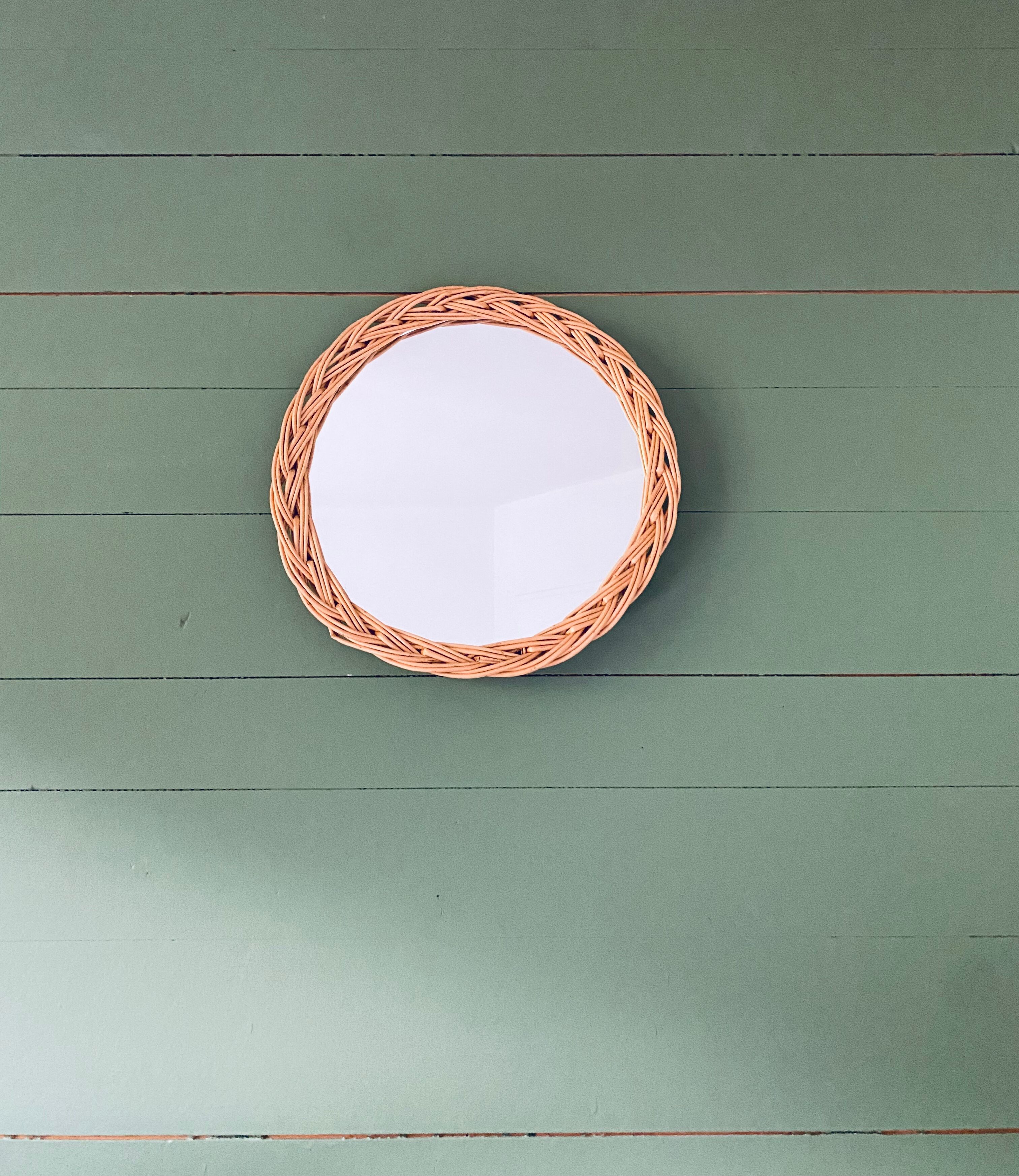 Round mirror in vintage wicker