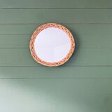 Round mirror in vintage wicker