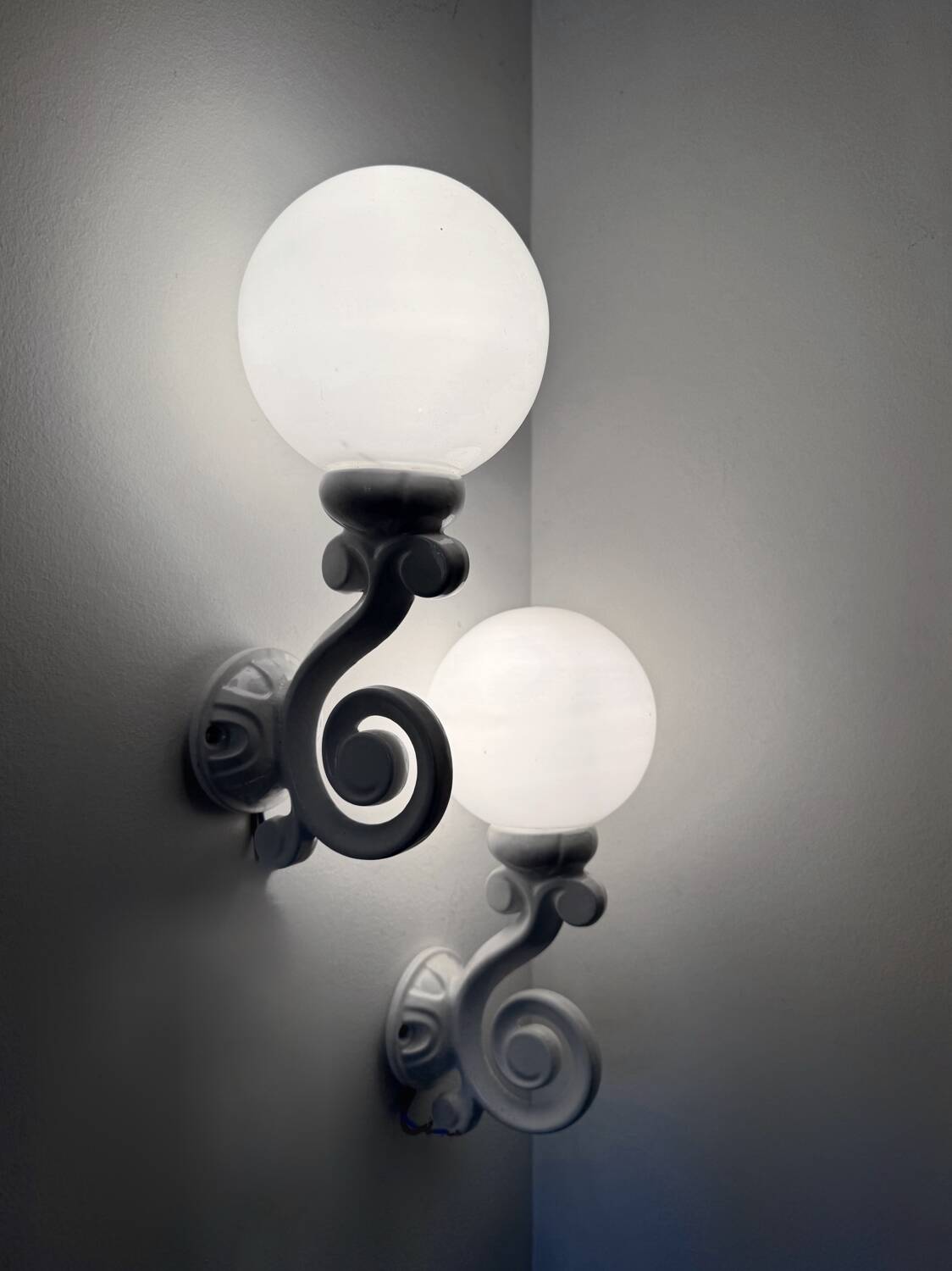Cast iron and opaline wall lights from the 70s