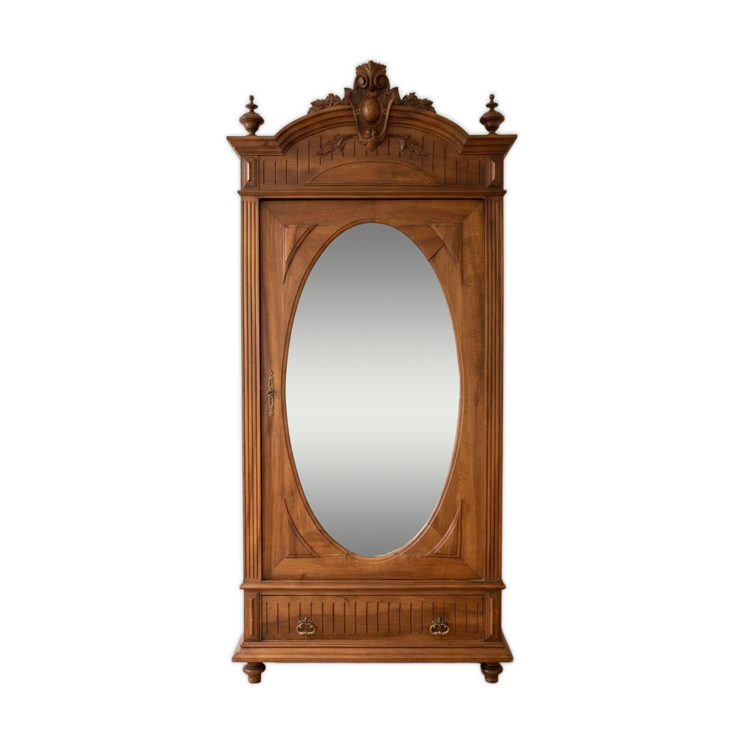 Antique solid wood wardrobe with an oval mirror.