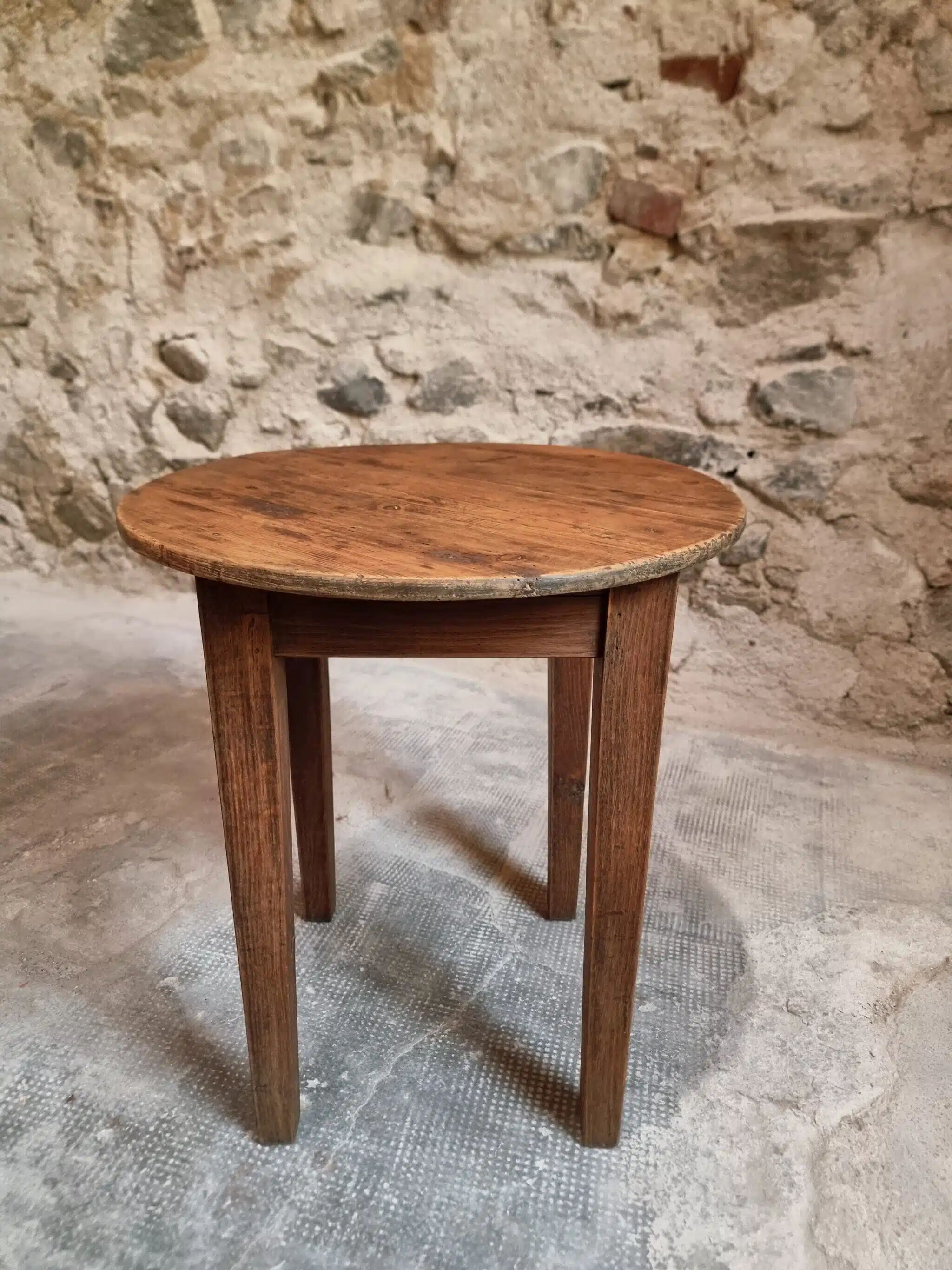 Antique round side table with oak legs and a pine top, circa 1900.