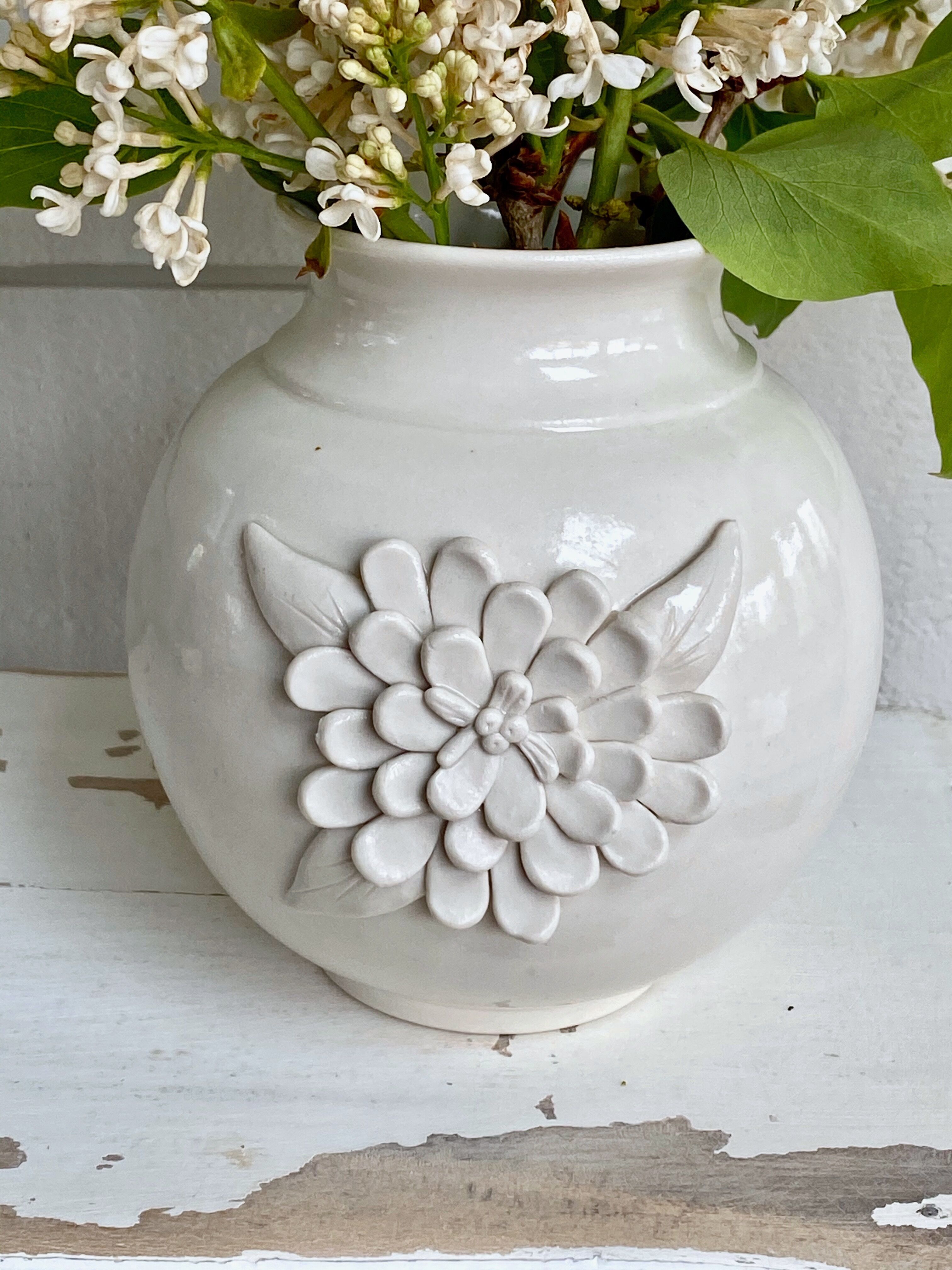 Small ceramic vase with floral relief