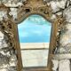 Carved and gilded wooden wall mirror.