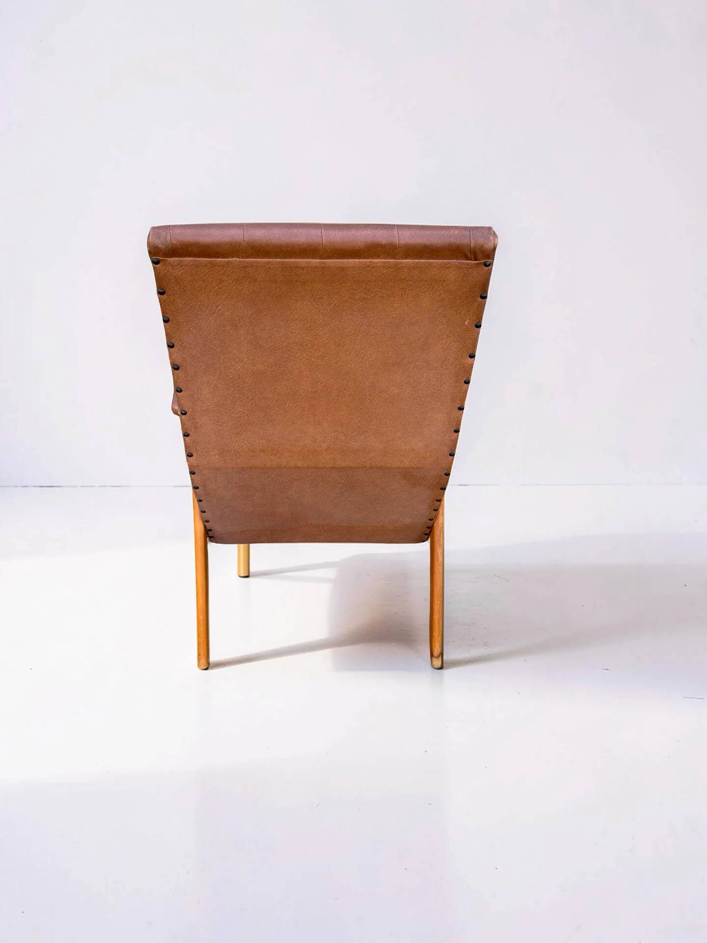 Vintage armchair in light brown faux leather, 1960s.