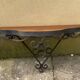 Old wrought iron console with a fleur-de-lis design.