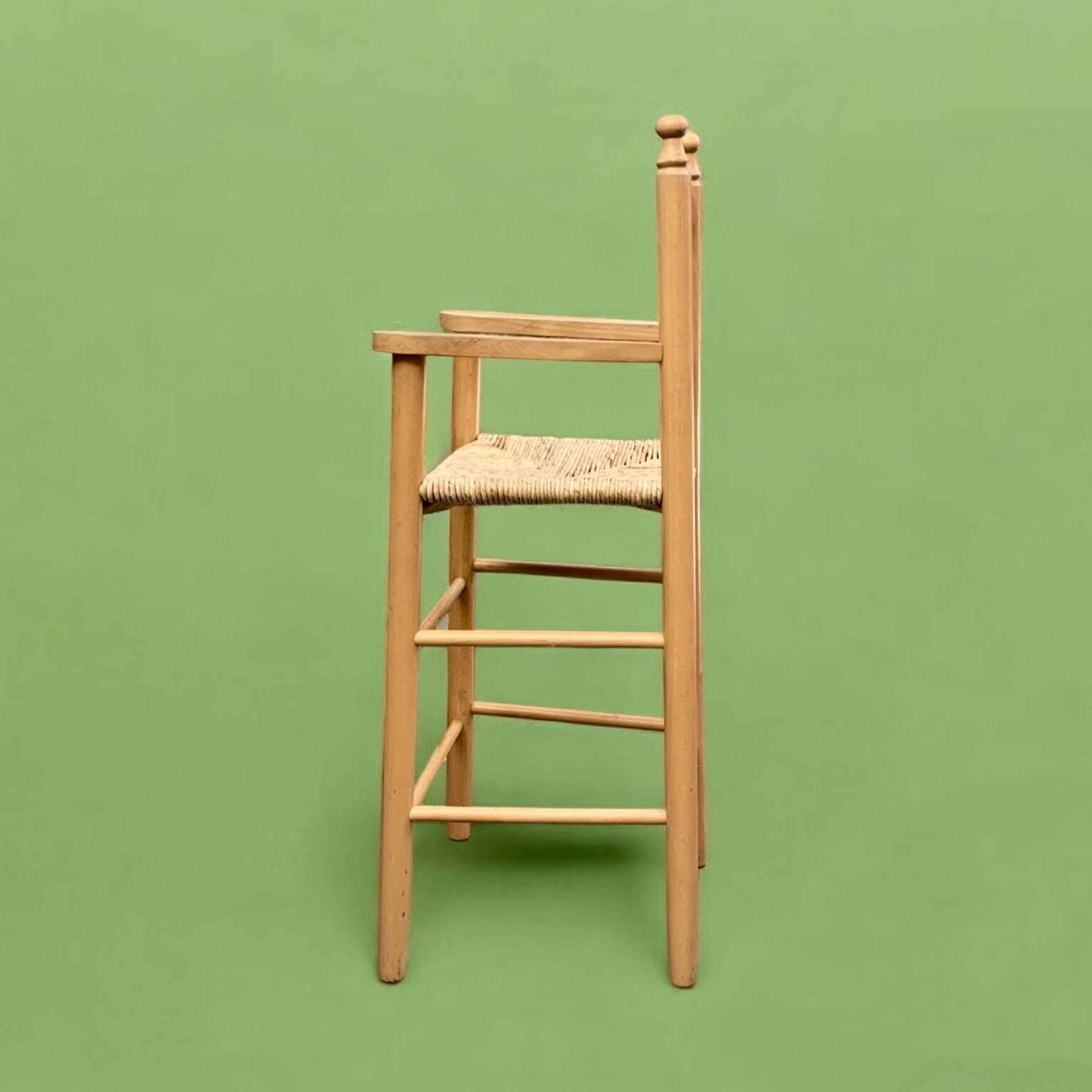 Old wooden and straw high chair for children