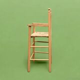 Old wooden and straw high chair for children