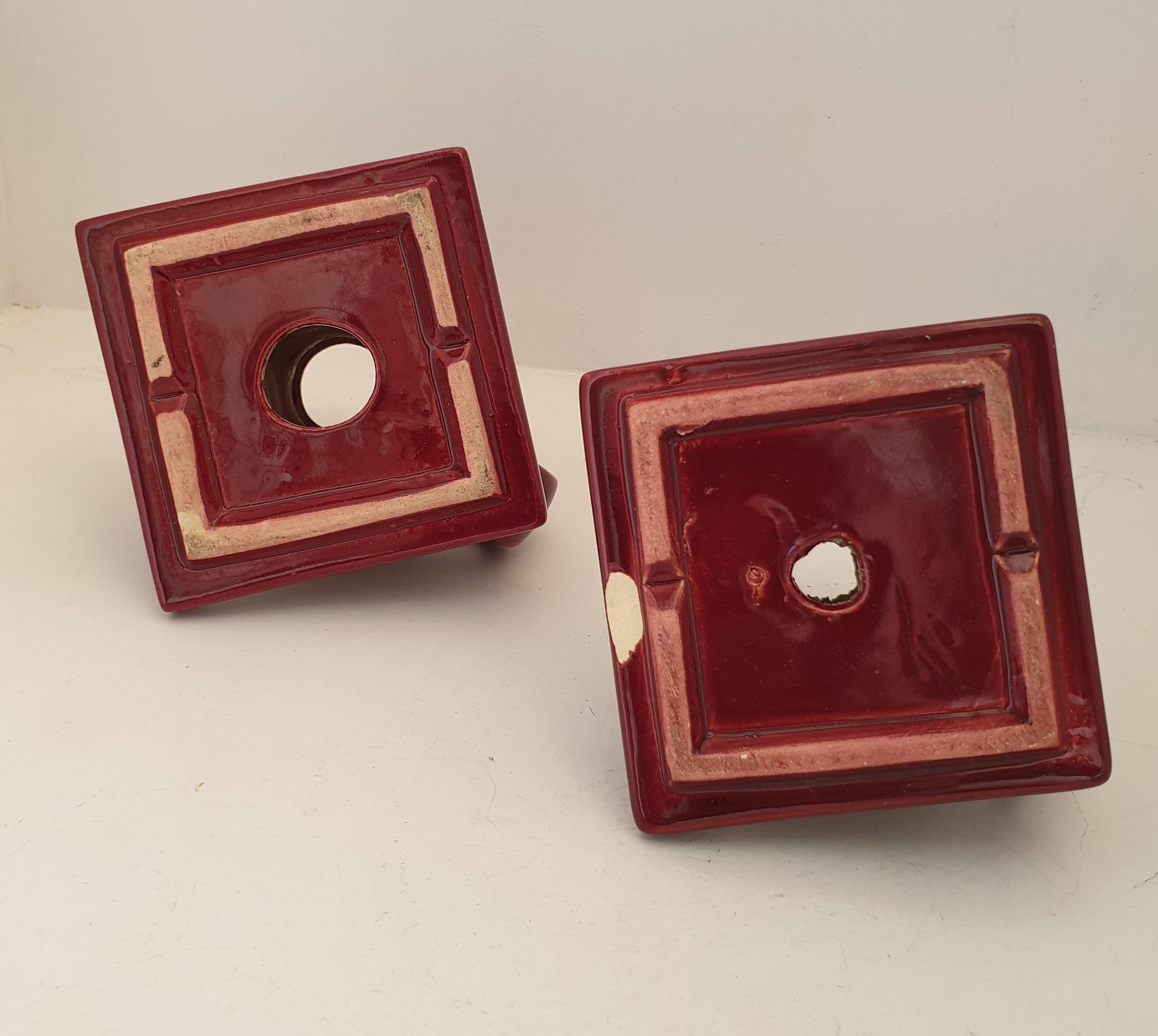 Pair of art deco candlesticks in bordeaux ceramics