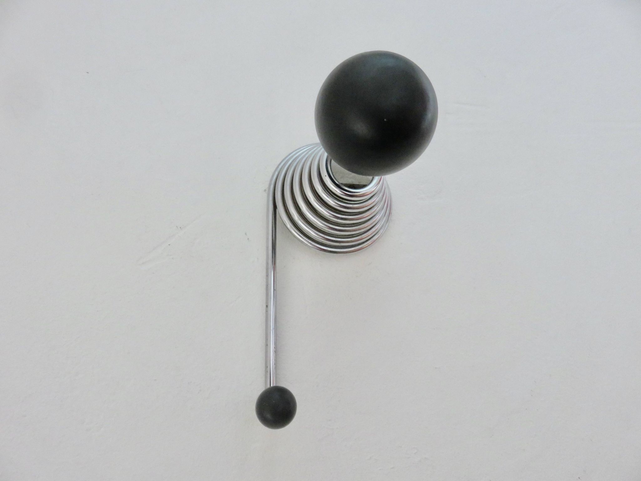 "Streamline" wall coat rack in chromed metal and black lacquered wood, 1970.