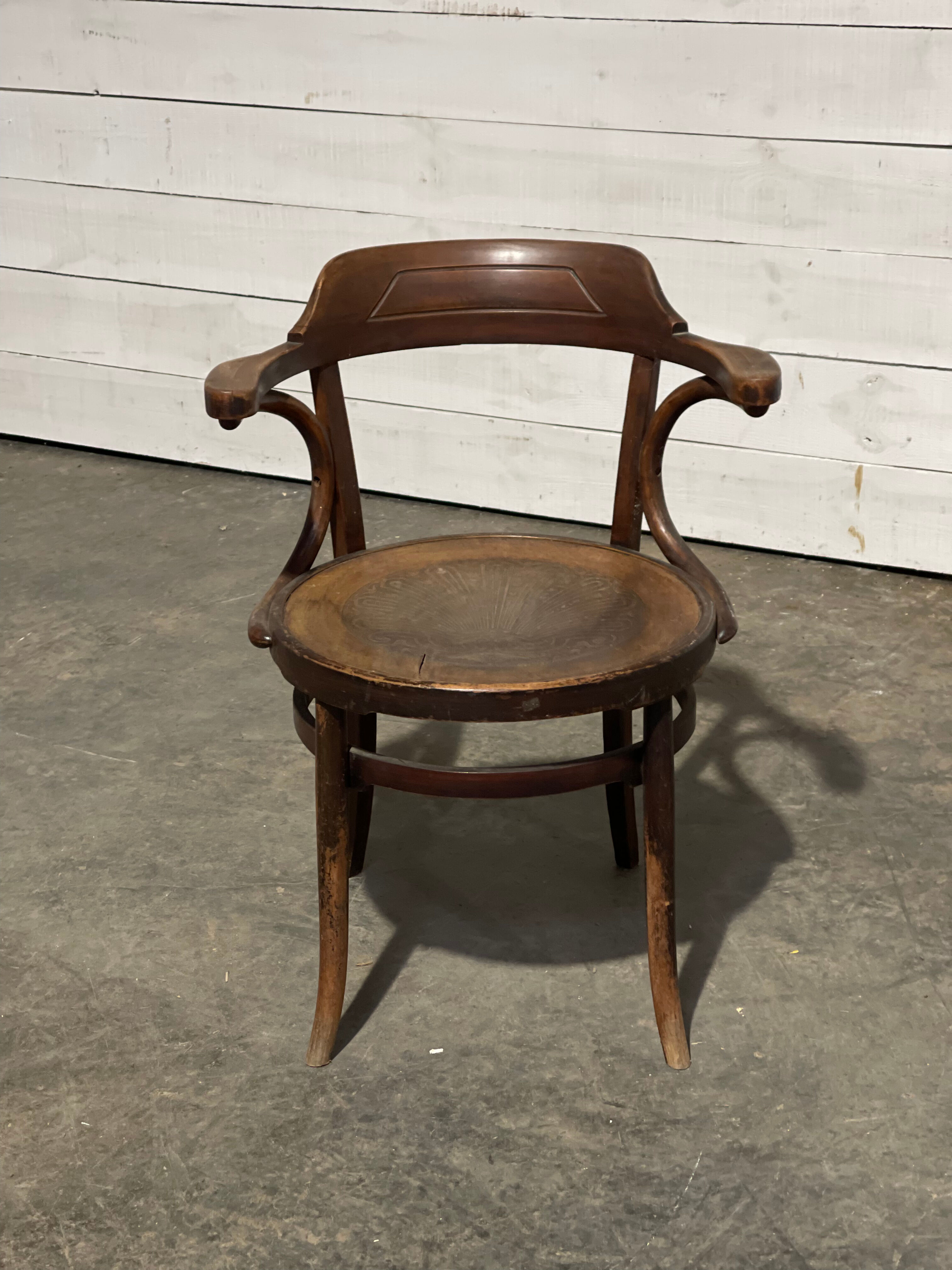 Curved wooden armchair