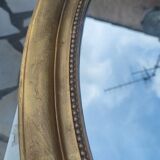Ovoid mirror with double pediments gilded with leaf circa 1830, 105x66 cm