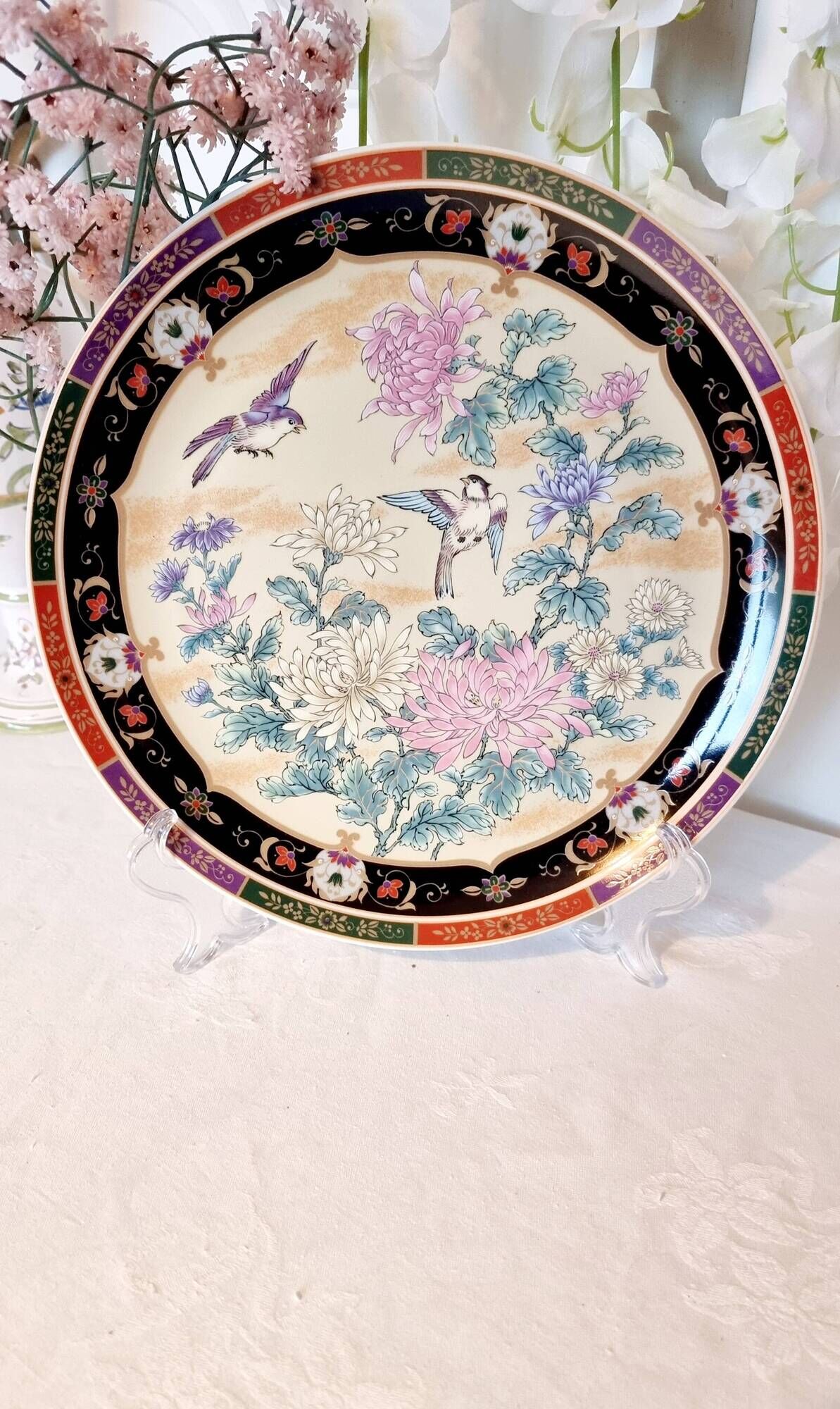 Vintage Japanese decorative plate with chrysanthemum and bird patterns.