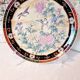 Vintage Japanese decorative plate with chrysanthemum and bird patterns.